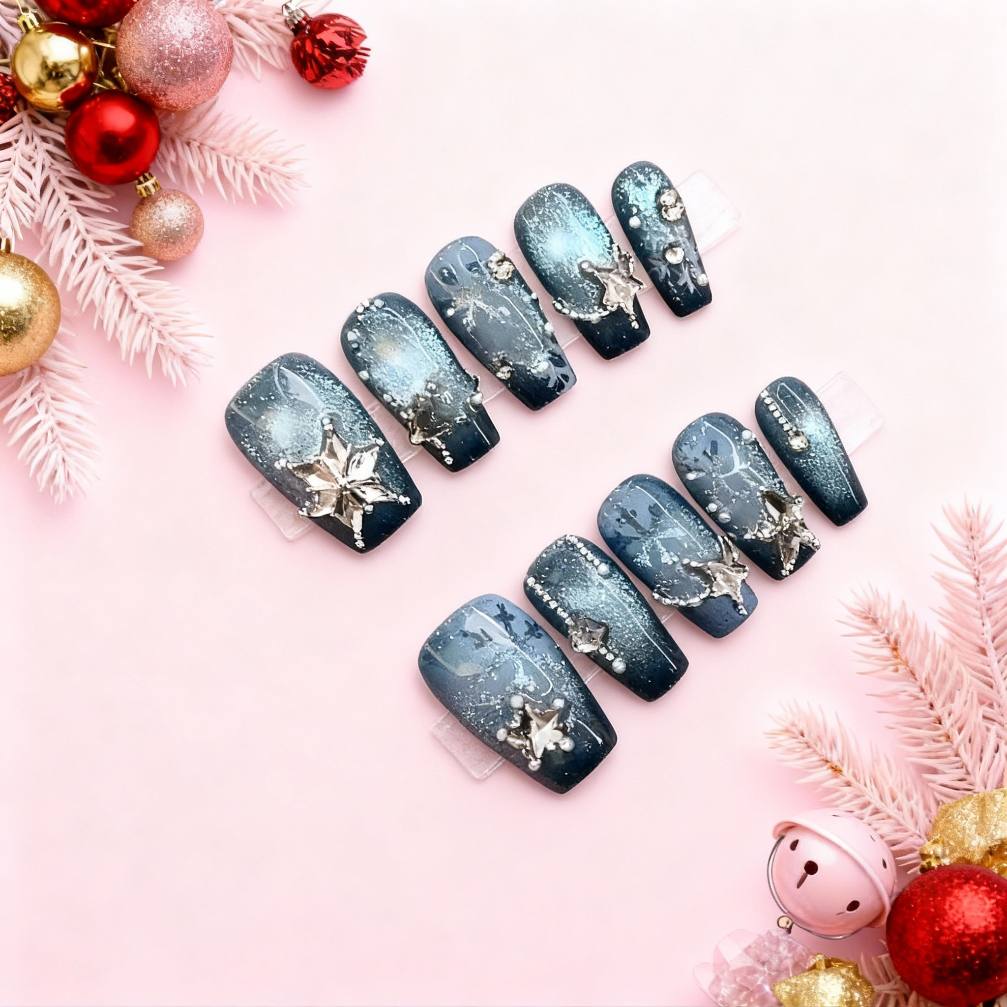 blue winter press-on nails with gem snowflakes and frosted snowflake patterns on a deep frostlake background