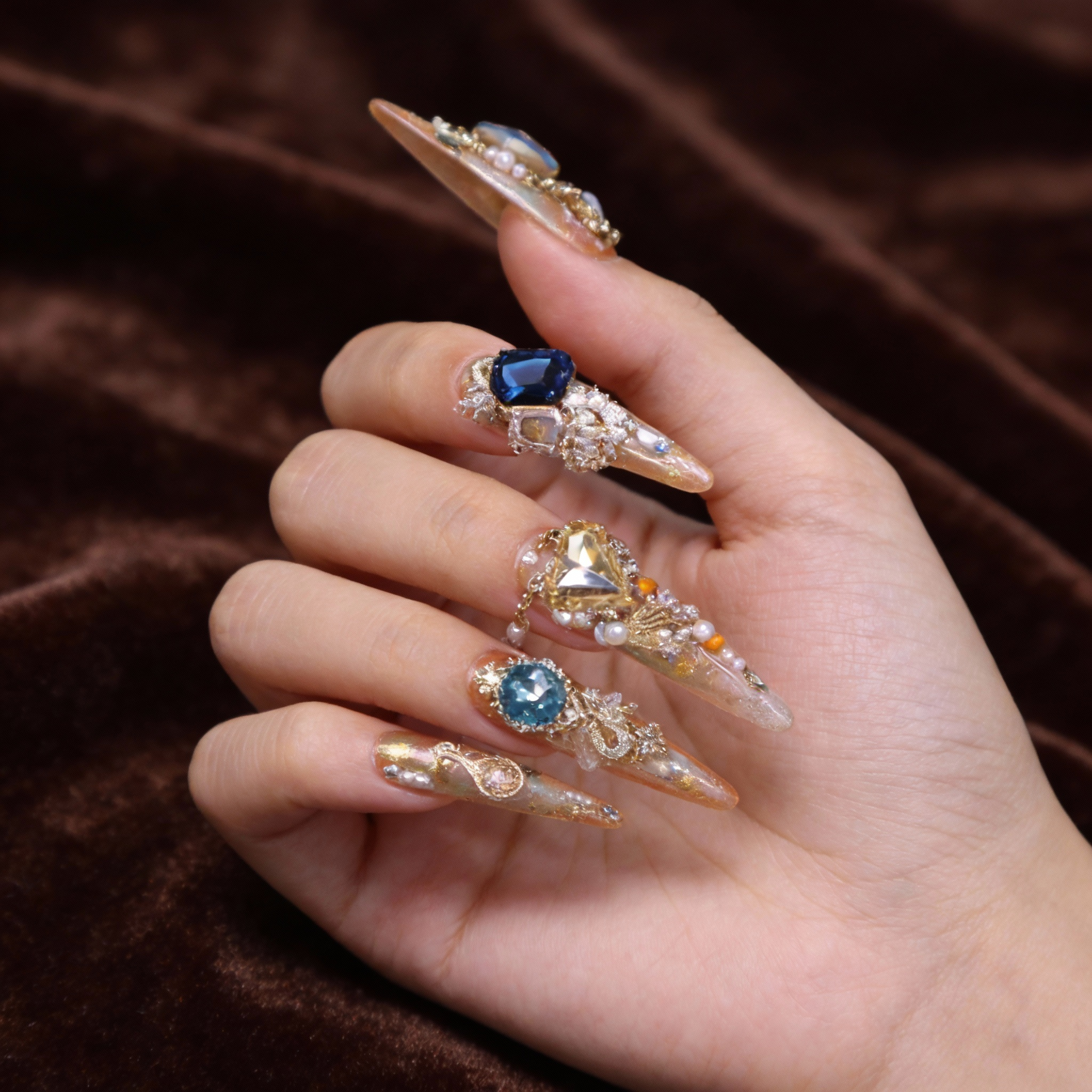 Close-up of Silk Road press on nails highlighting crystal, zircon, and metallic detailing inspired by ancient trade routes