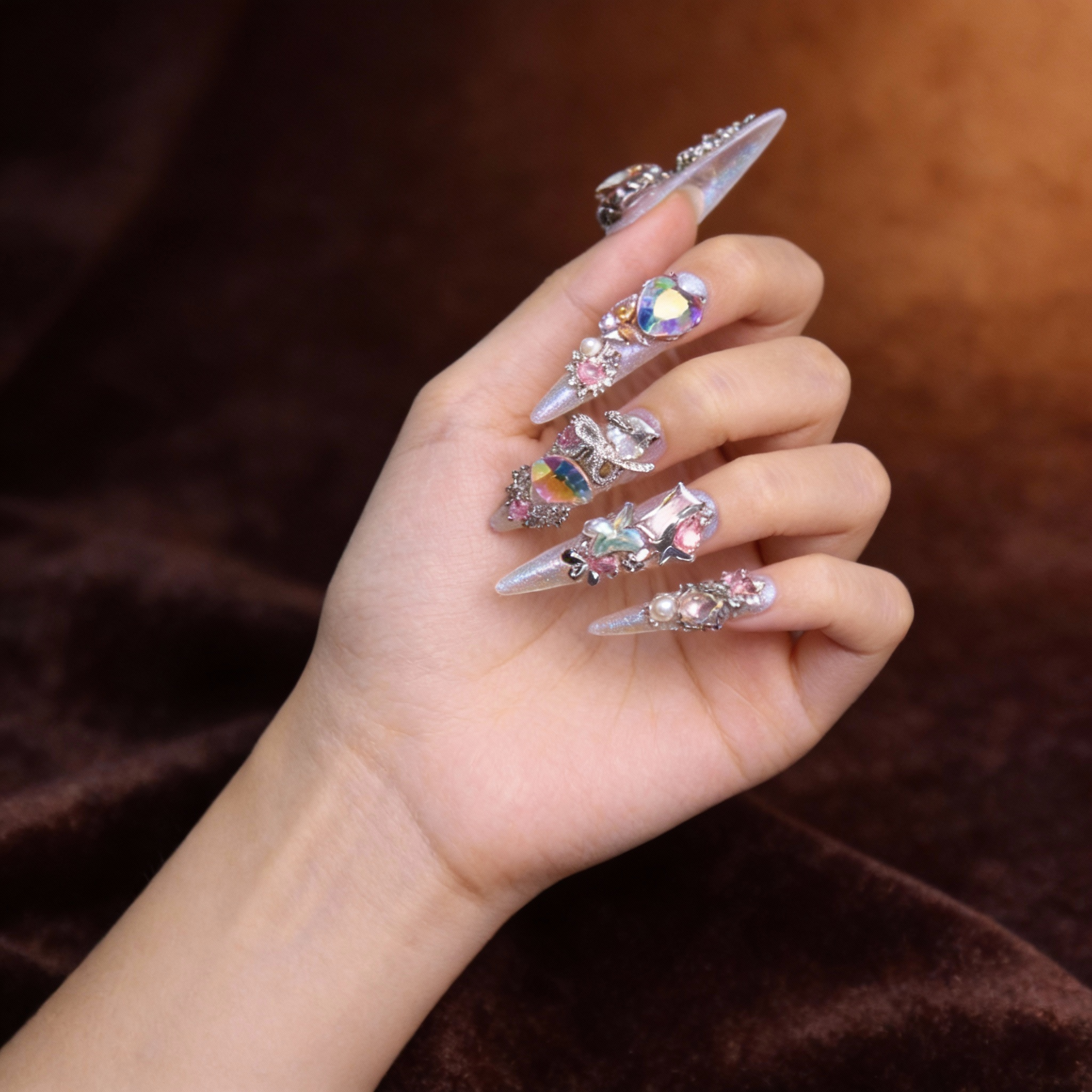 Close-up of La Trace press on nails with prismatic sparkle, crystal details and glass-like translucent texture