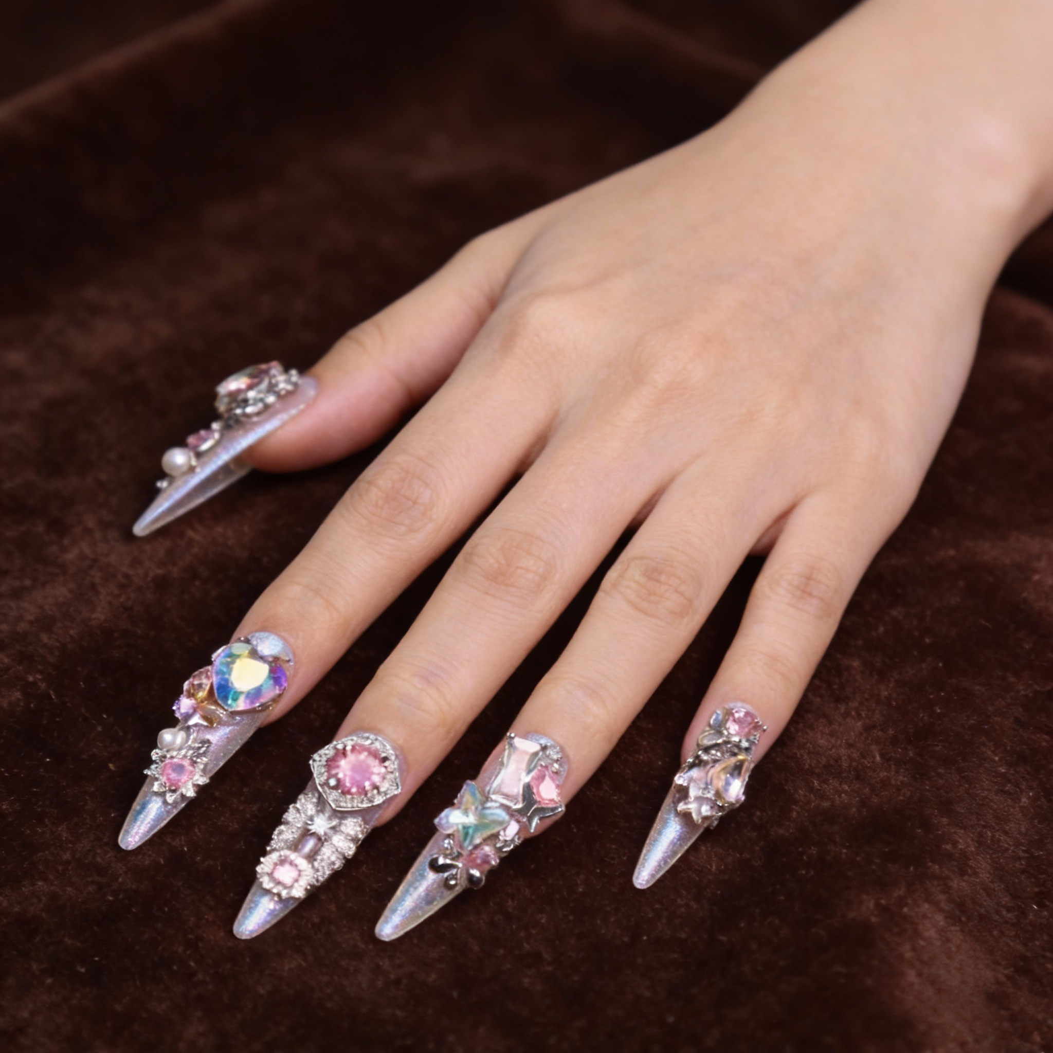 Close-up of La Trace press on nails with prismatic sparkle, crystal details and glass-like translucent texture