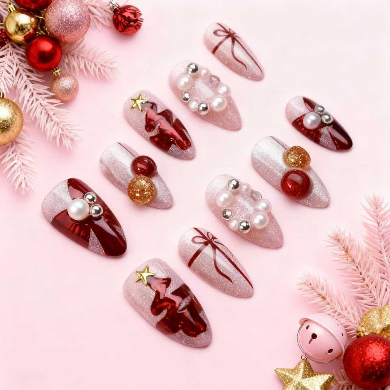 red Christmas tree press-on nails with glitter pink base, ribbon accents and festive ornaments on holiday background