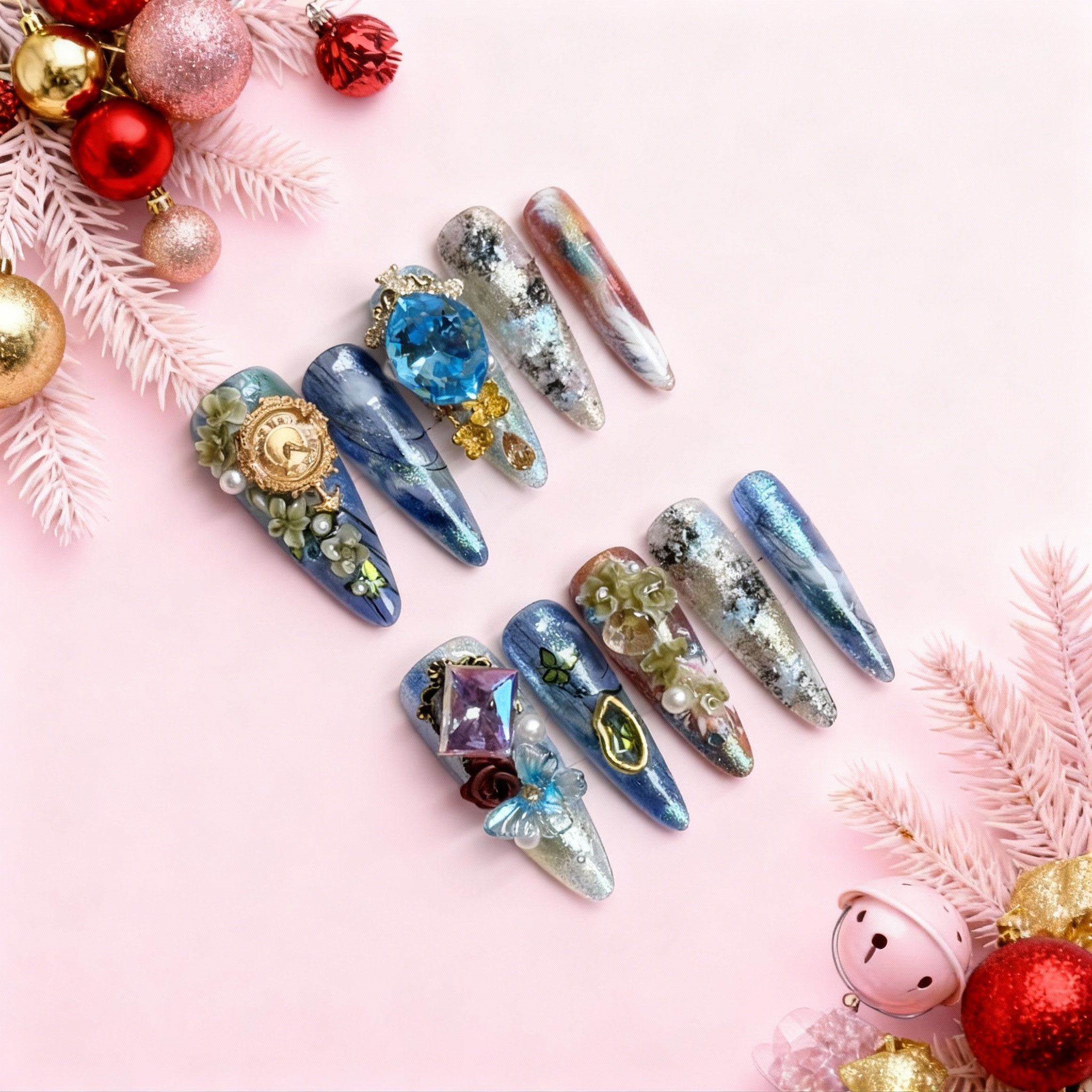 Luxury blue Christmas press on nails with a large sapphire gemstone, glacier marbling, silver foil textures and handcrafted floral crystal details.