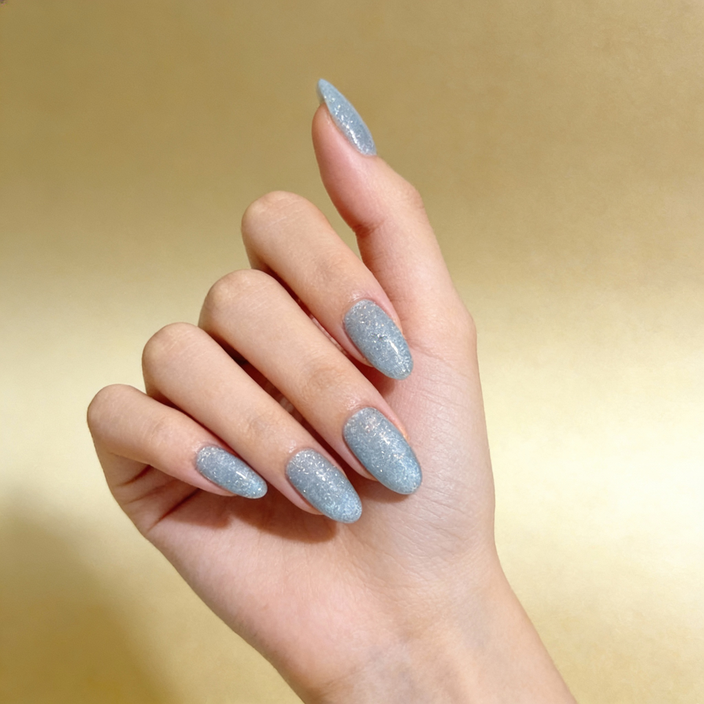 Blue winter nails with subtle sparkle, Icy Blue Sparkle design styled for a clean and elegant winter look.