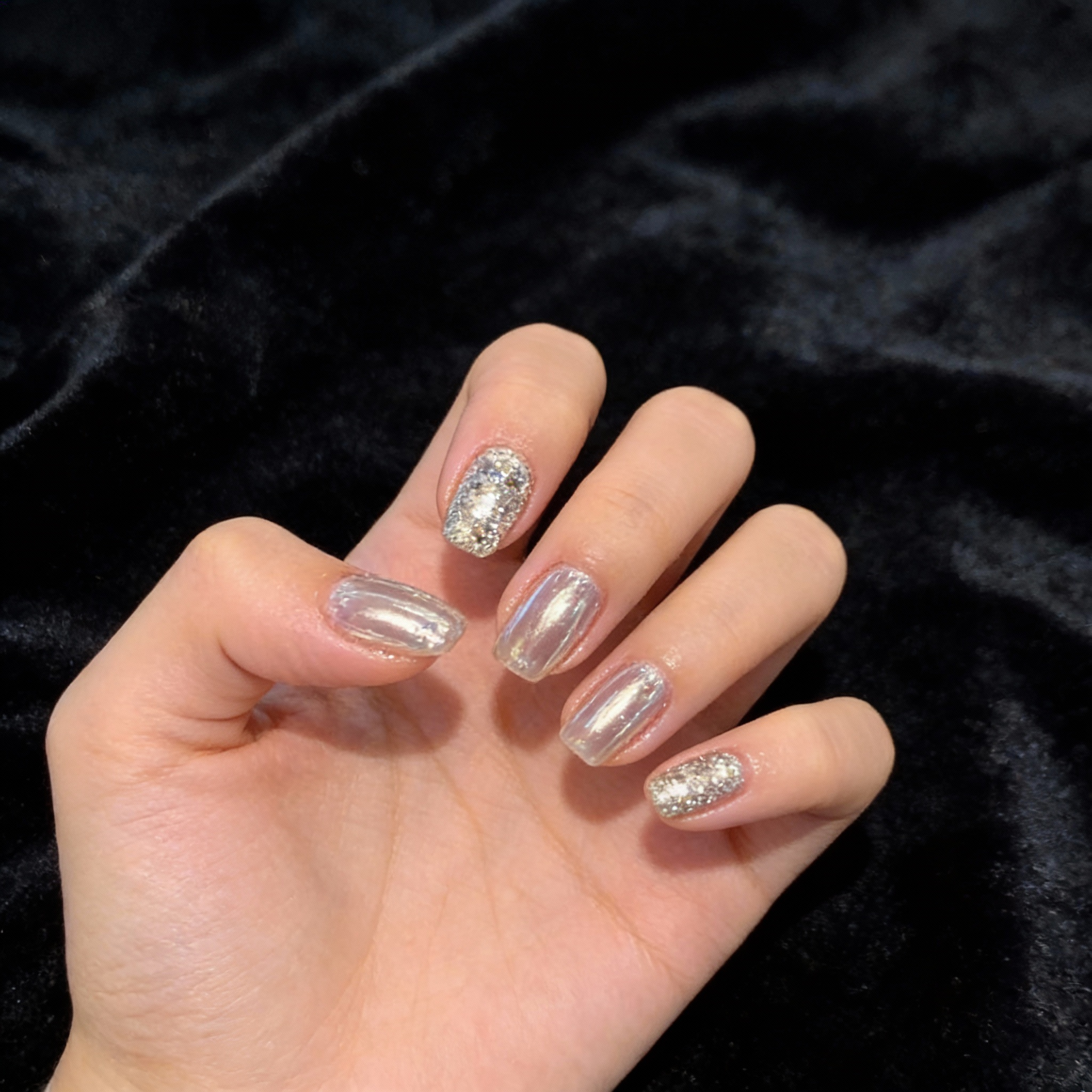 Modern winter nails with smooth mirror-effect surface and minimal crystal details