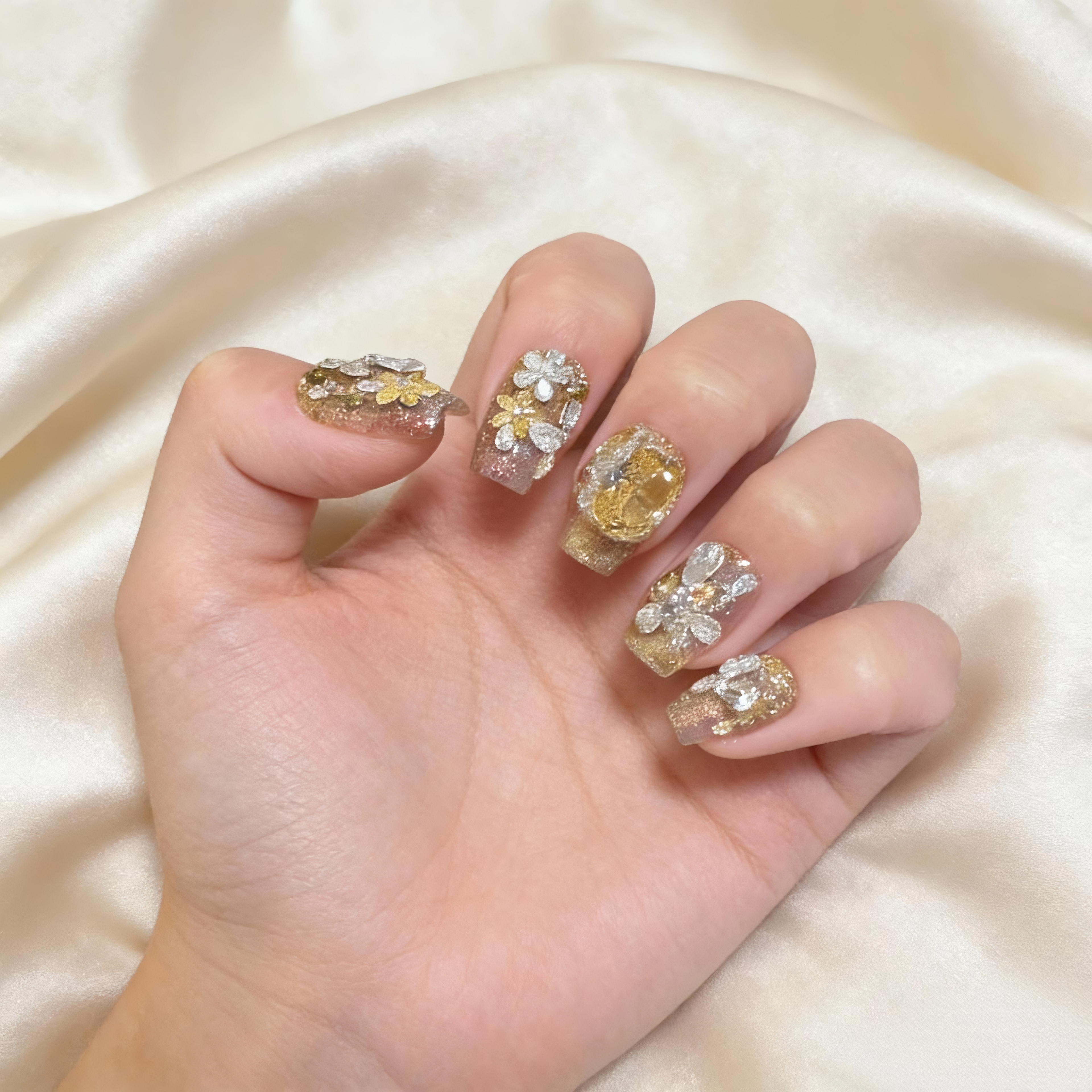 Sunlit Frost winter sparkly nails worn on hand with warm golden glow and frosted crystal details