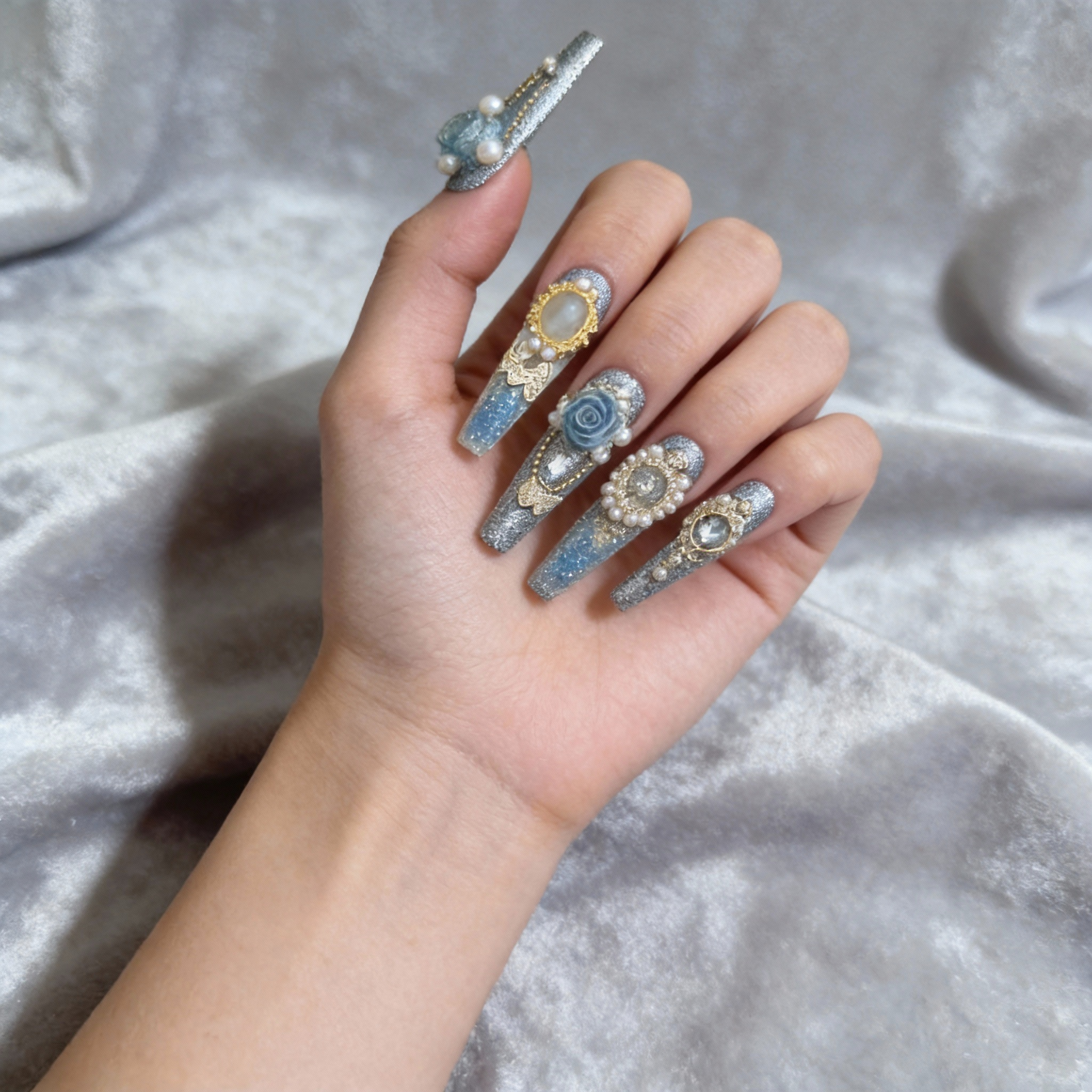 Blue gradient resin liquid nails with glitter jar effect shown on hand in natural light