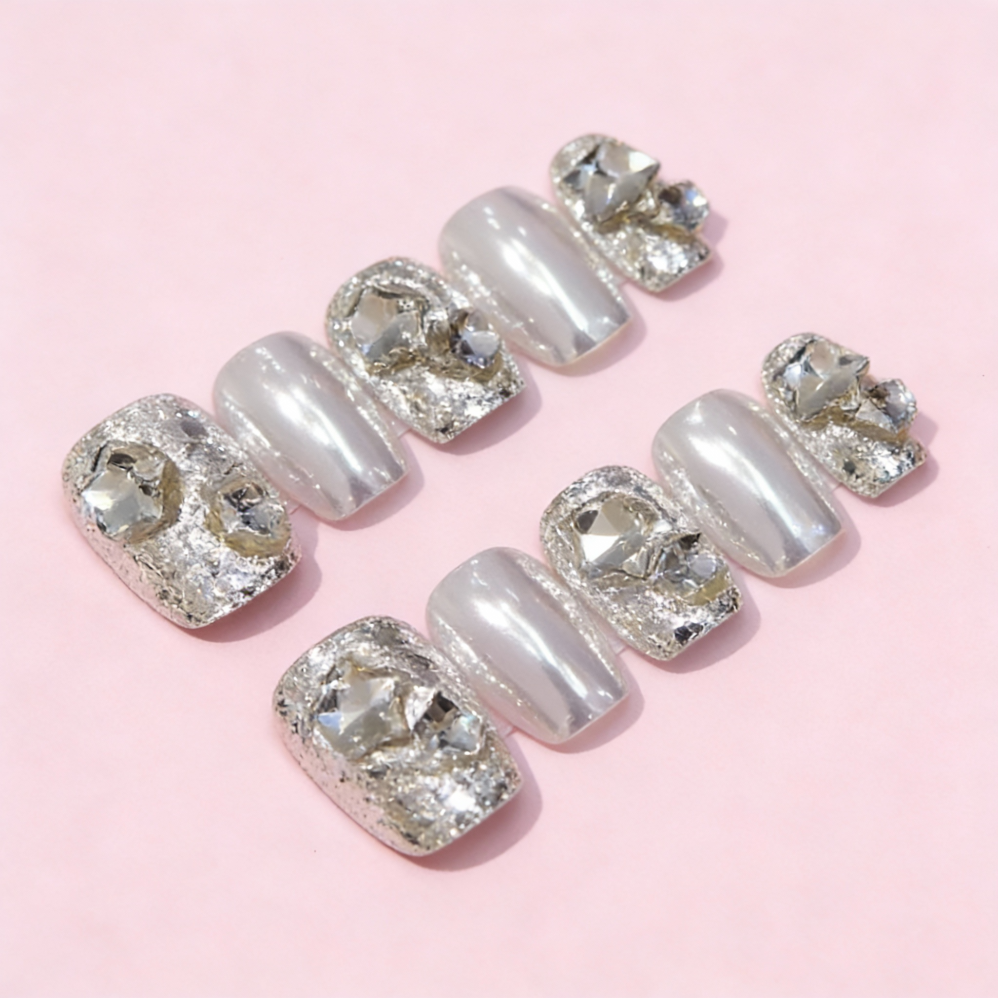 Winter sparkly nails featuring a high-shine mirror powder finish with icy silver crystals, creating a sleek and classy winter nails look