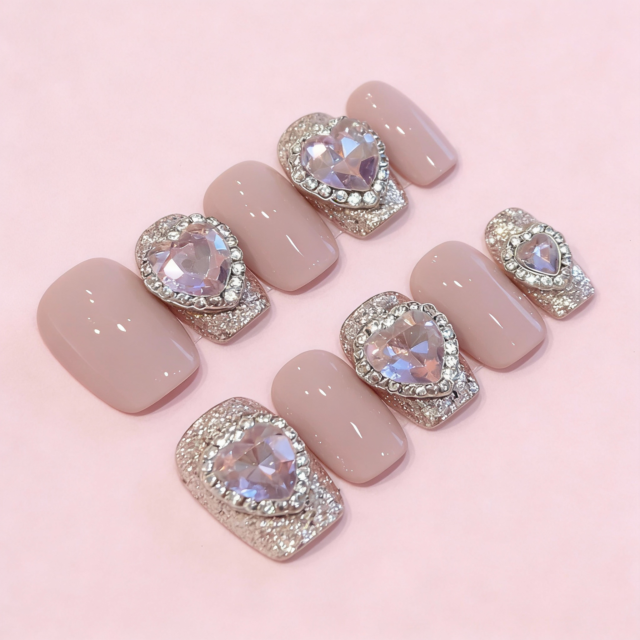 Winter Love Sparkle press-on nails featuring sparkly accents, glossy solid colors, and heart-shaped crystal embellishments, cute winter sparkly nails design