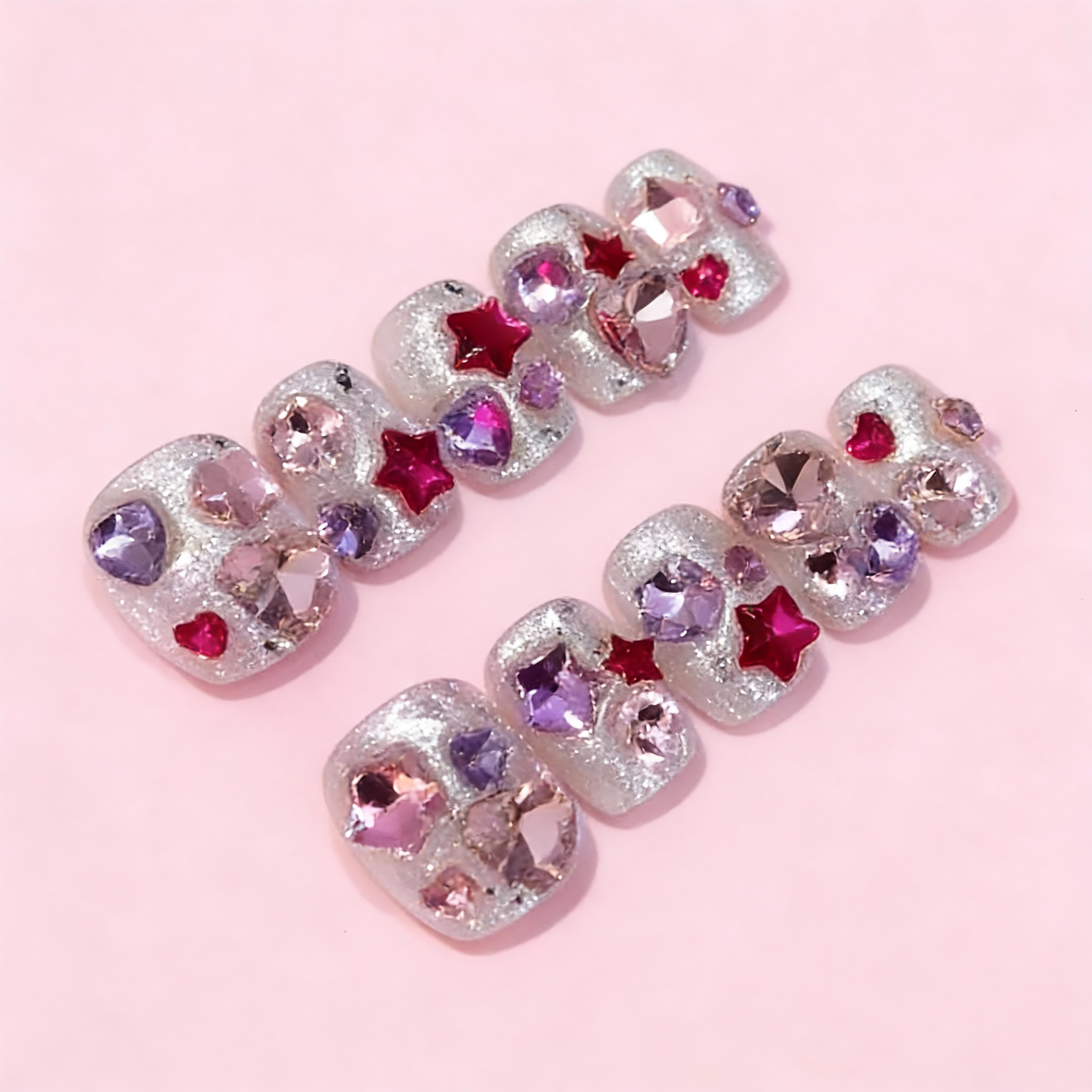 Close-up of winter sparkly nails featuring celestial star accents and soft glitter shimmer