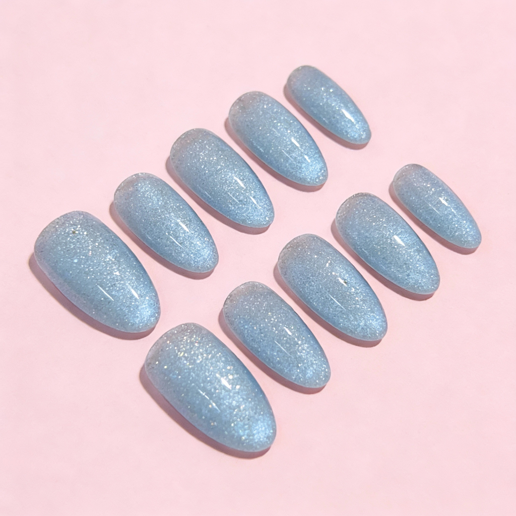 Icy Blue Sparkle press-on nails featuring an icy blue base with fine shimmer, a clean winter sparkly nails design.
