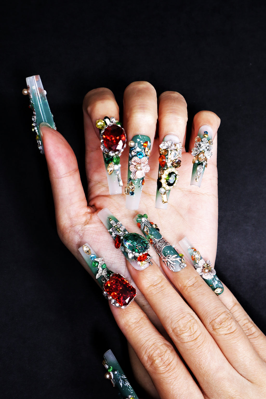 Hand-worn emerald green luxury press on nails with couture embroidery details and fine crystal accents