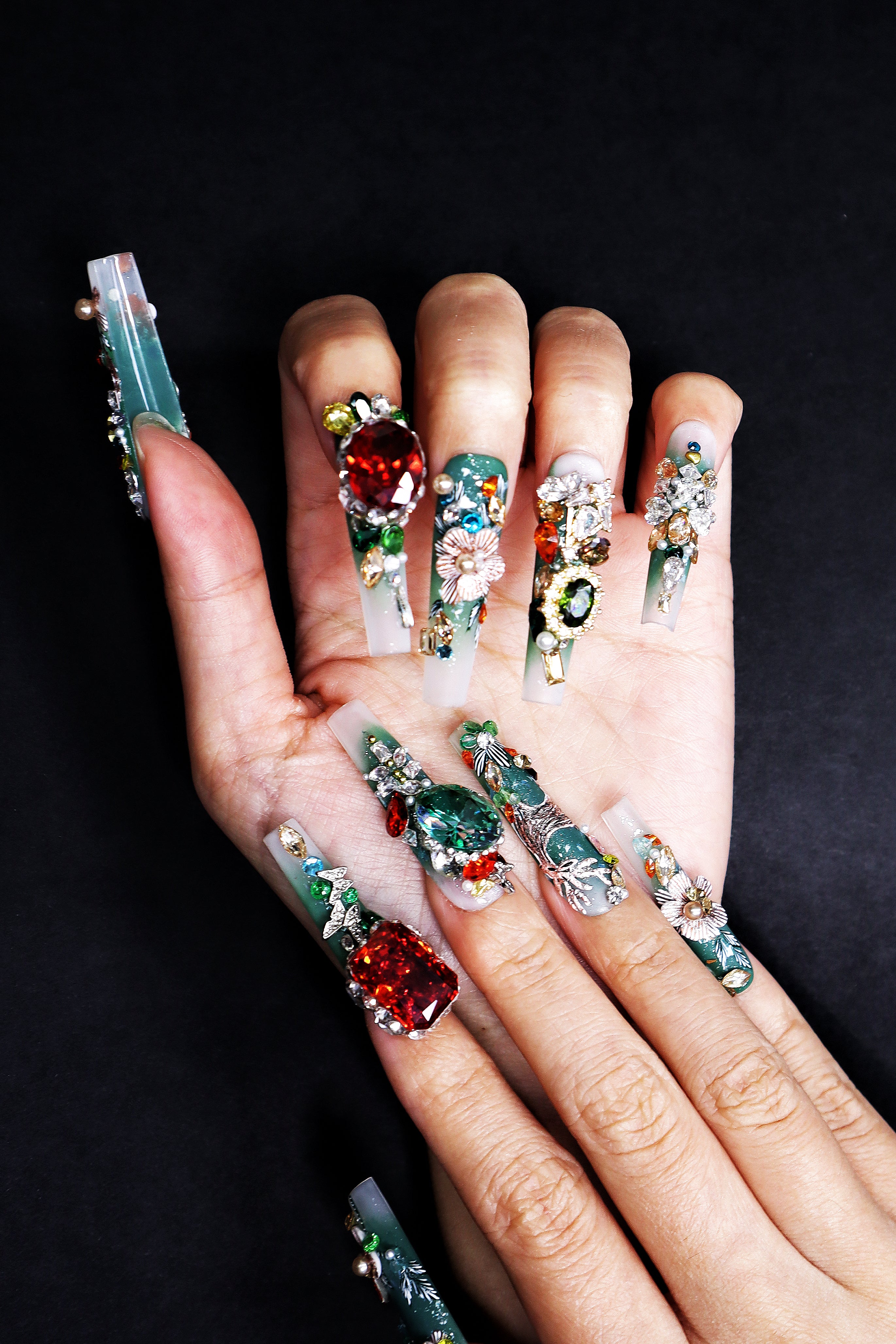 Hand-worn emerald green luxury press on nails with couture embroidery details and fine crystal accents