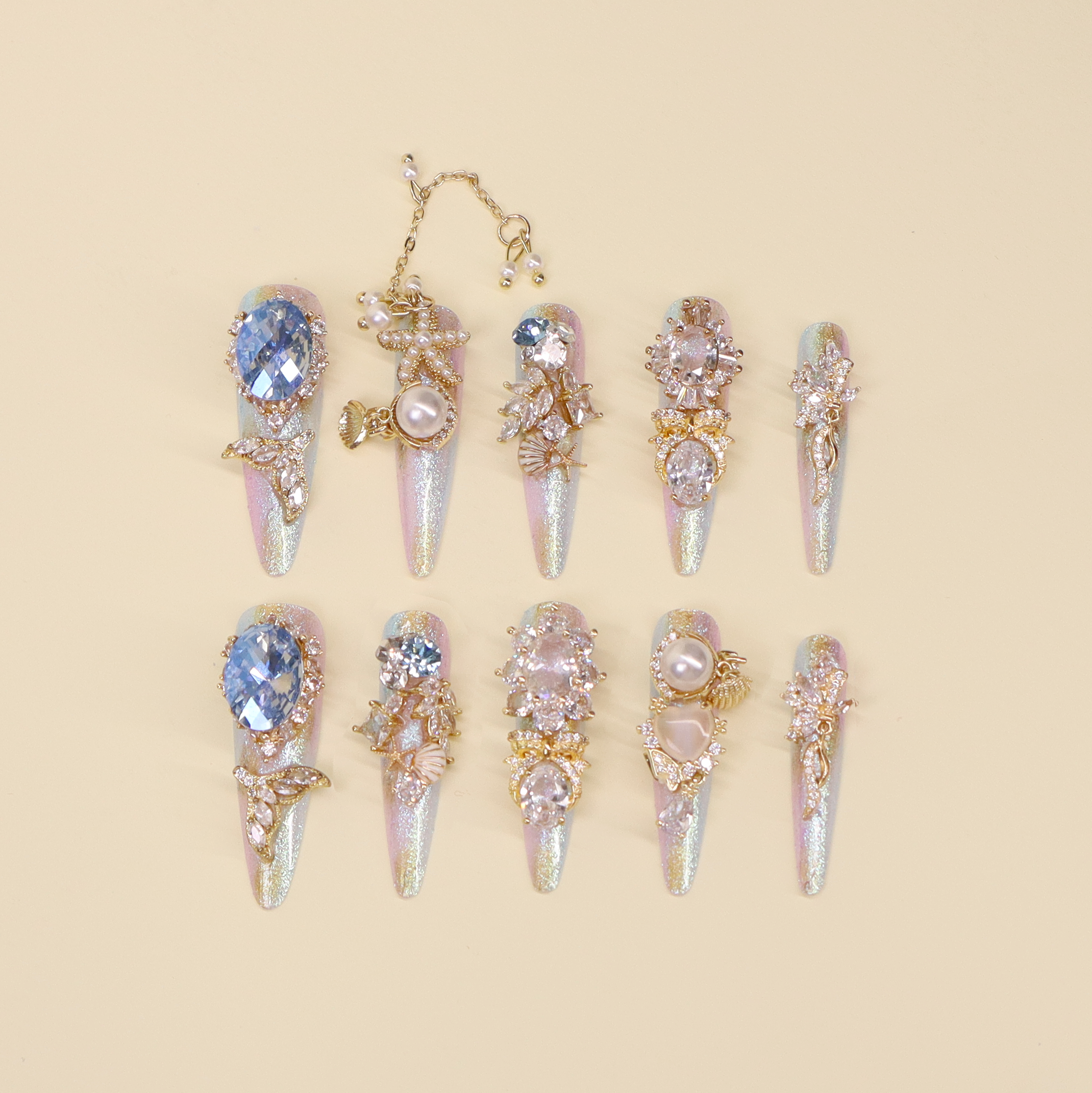 Mermaid sparkly press on nails with icy blue and lavender shimmer, pearls, shells, and ocean crystal accents