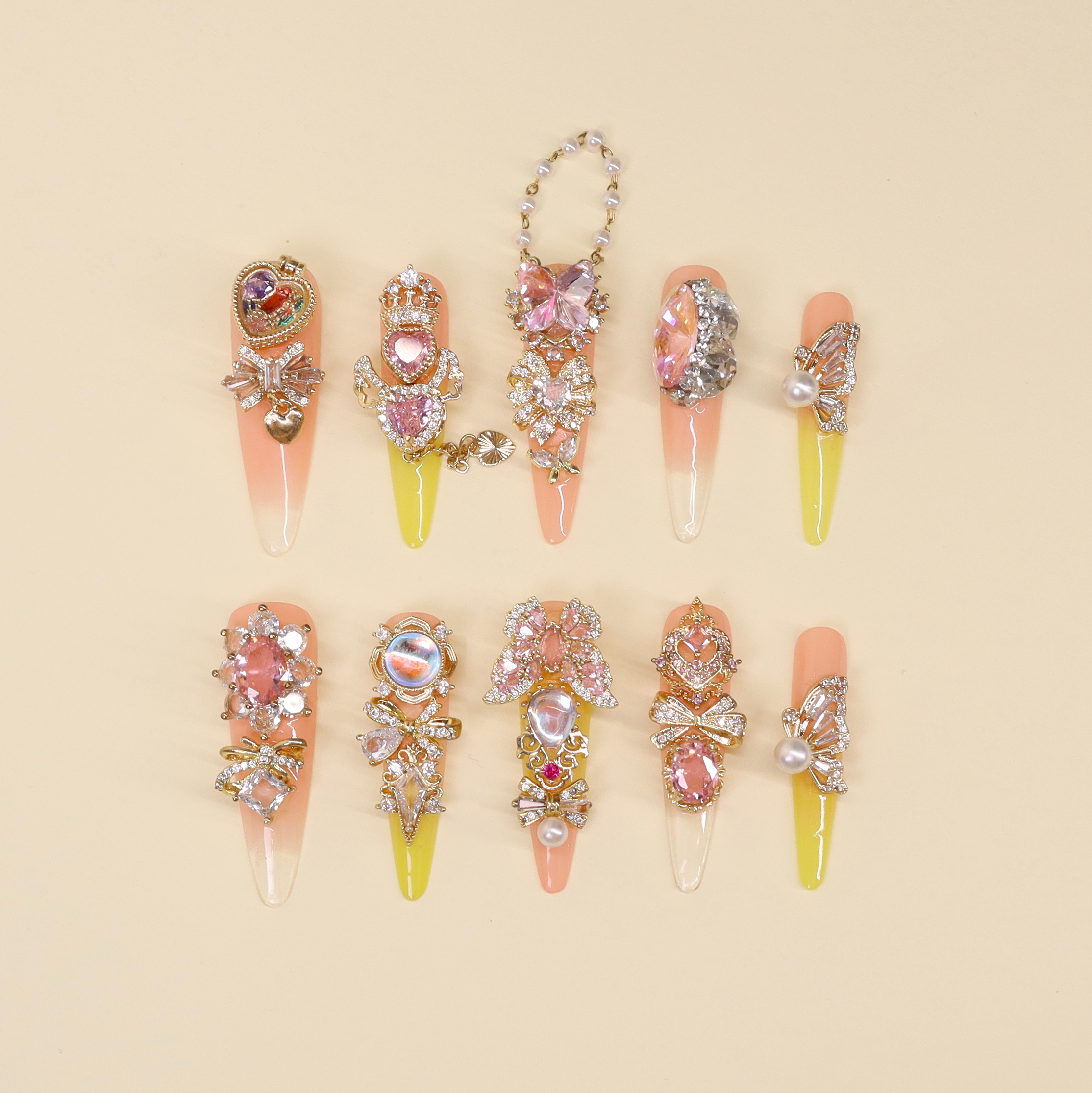 Secret Jewel Box luxury press on nails featuring pink and red gradient design with opening heart locket charm, crystal and pearl nail art