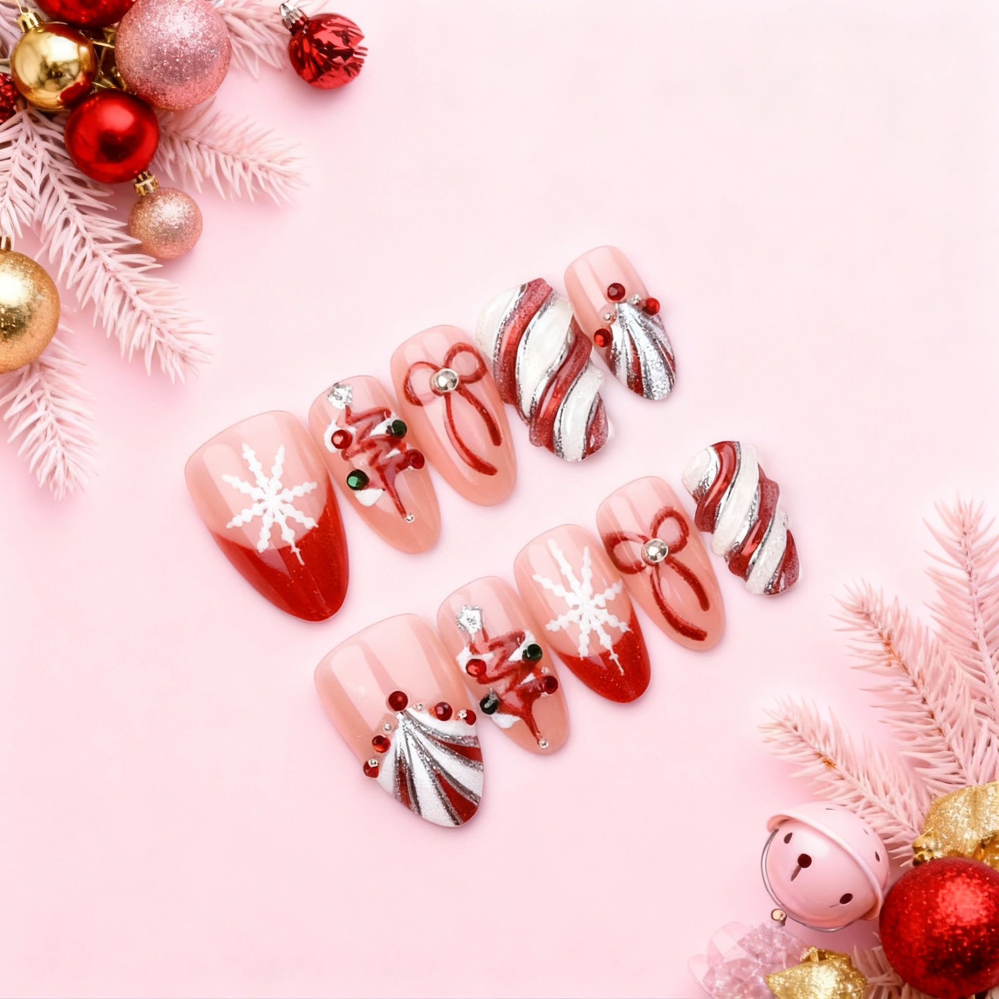 Red and white candy swirl Christmas press on nails with silver glitter, snowflakes and ribbon designs arranged on a pink holiday background.