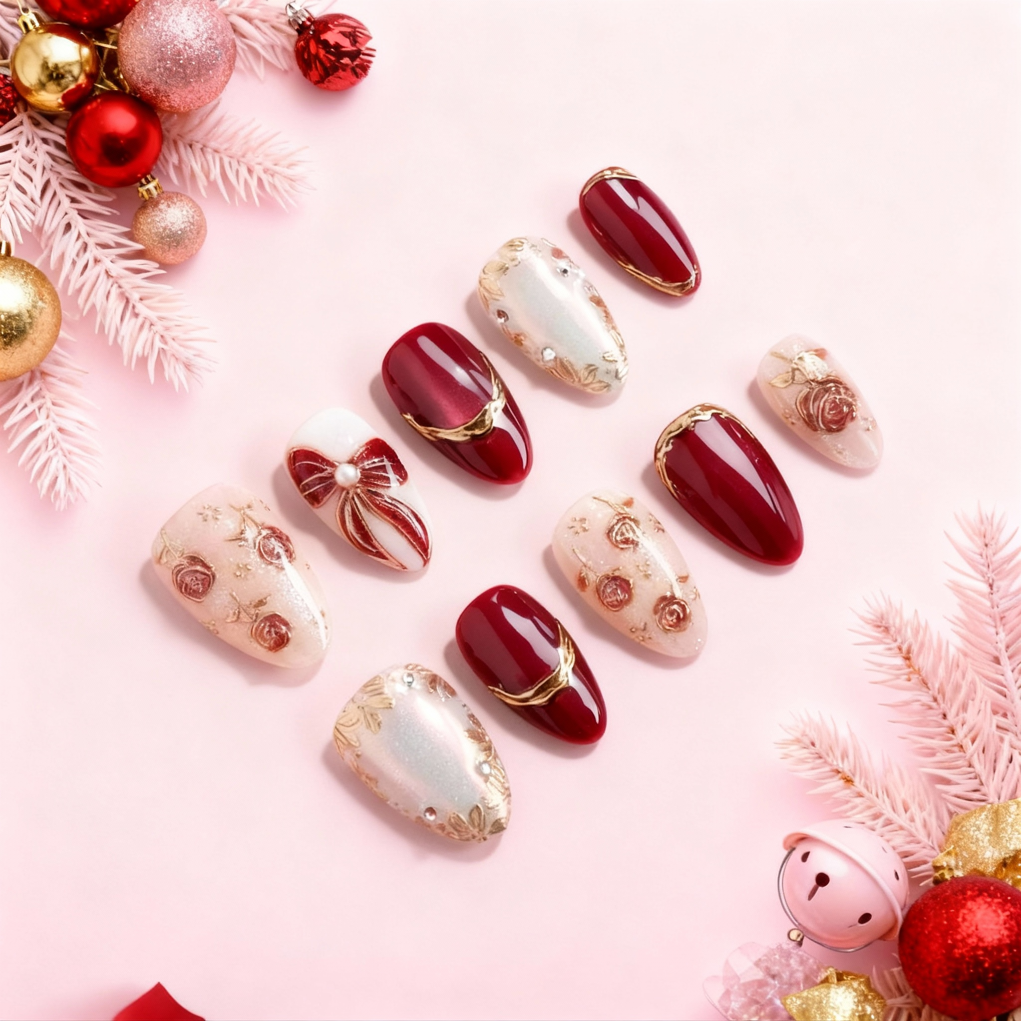 Christmas Velvet Rose press-on nails on pink background – red velvet and pearl white Christmas nails with rose patterns, gold accents and ribbon bow charm.